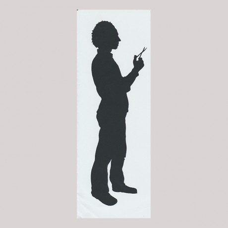
        Front of silhouette, with standing man looking right, with scissors.